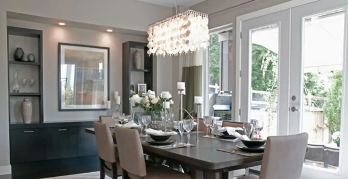 Elegant dining room chandelier installation above table in Austin, TX