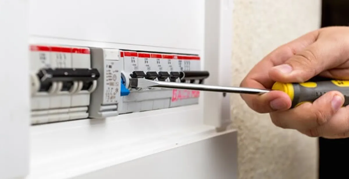 electrical panel upgrade service showing technician adjusting circuit breakers during system upgrade in Austin, TX