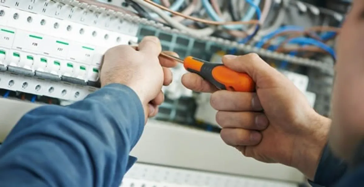 electrical service showing licensed electrician performing electrical panel maintenance and adjustments in Austin, TX