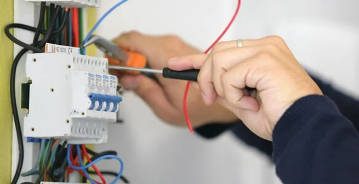 Electrician installing and adjusting circuit breakers in an electrical panel in Austin, TX