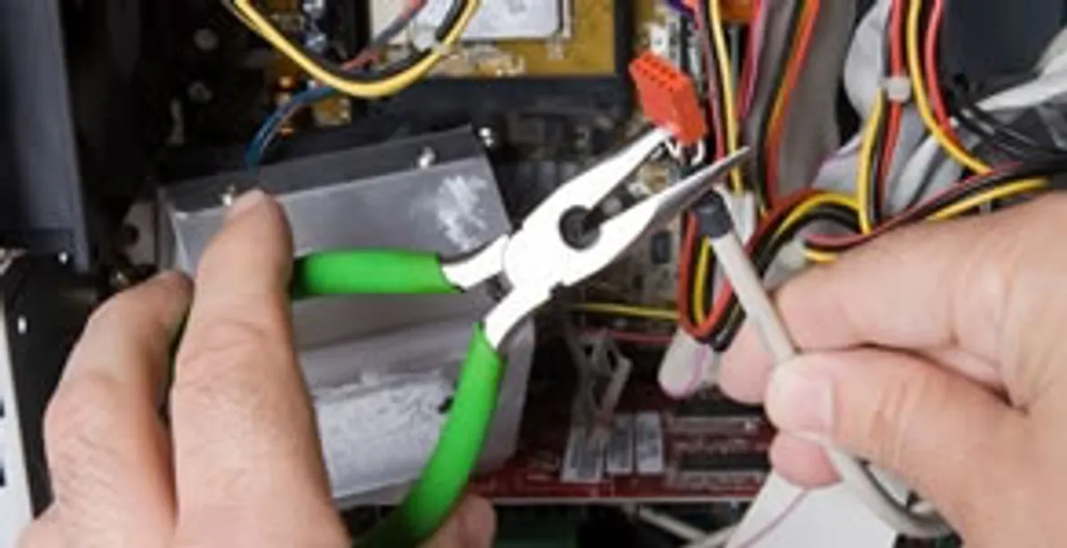 Licensed electrical contractor performing electrical repair with tools in Buda, TX