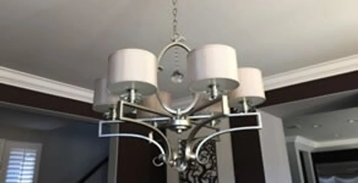 Modern chandelier installation with multiple light fixtures in Austin, TX
