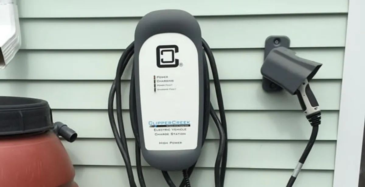 Outdoor electric vehicle charger installation on residential wall in Austin, TX
