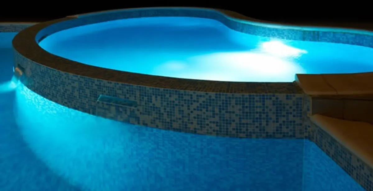 pool light installation and repair services highlighting illuminated pool interior lighting in Austin, TX