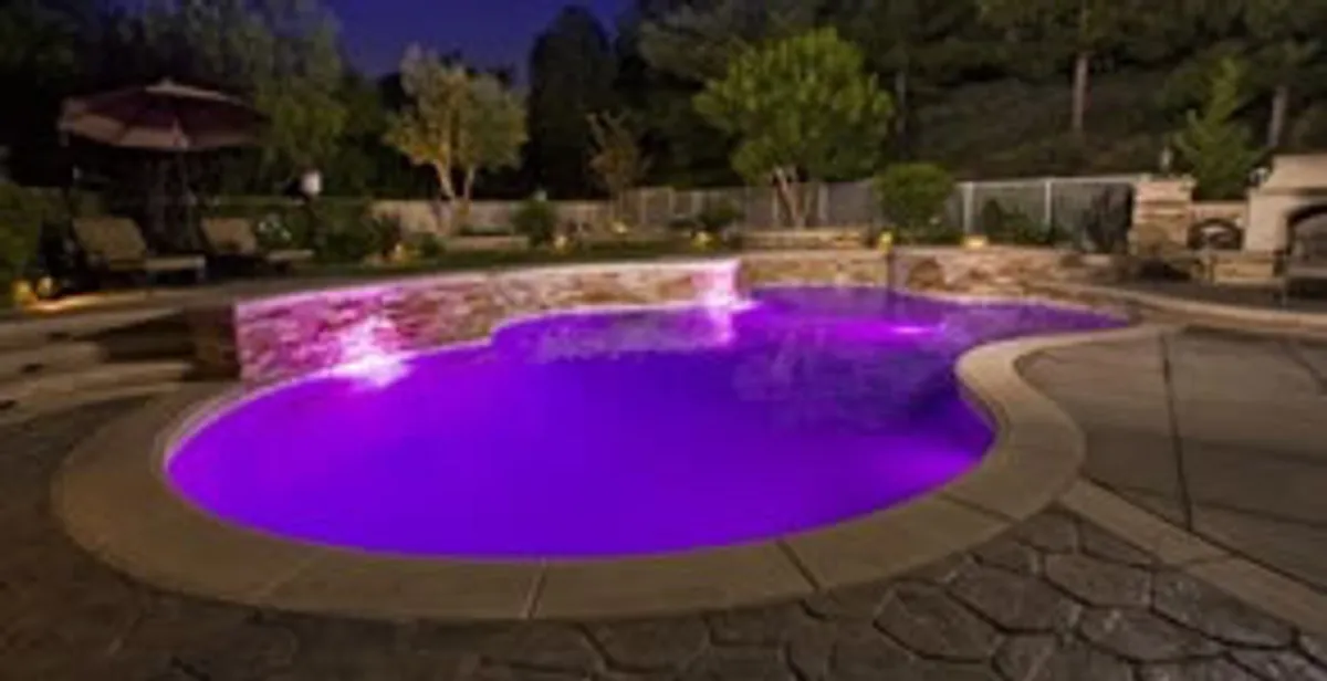 pool light installation and repair services illuminating a residential swimming pool in Austin, TX